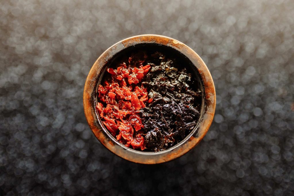 Colorful hookah coals in a bowl.